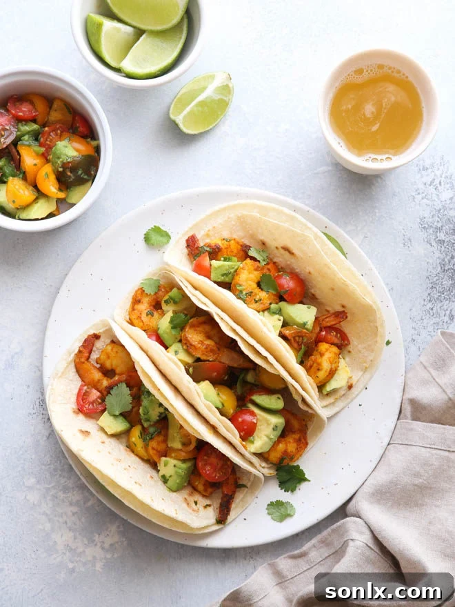 Vibrant Mumbai Spiced Shrimp Tacos with Avocado Salsa on a rustic wooden board, garnished with fresh cilantro and lime wedges