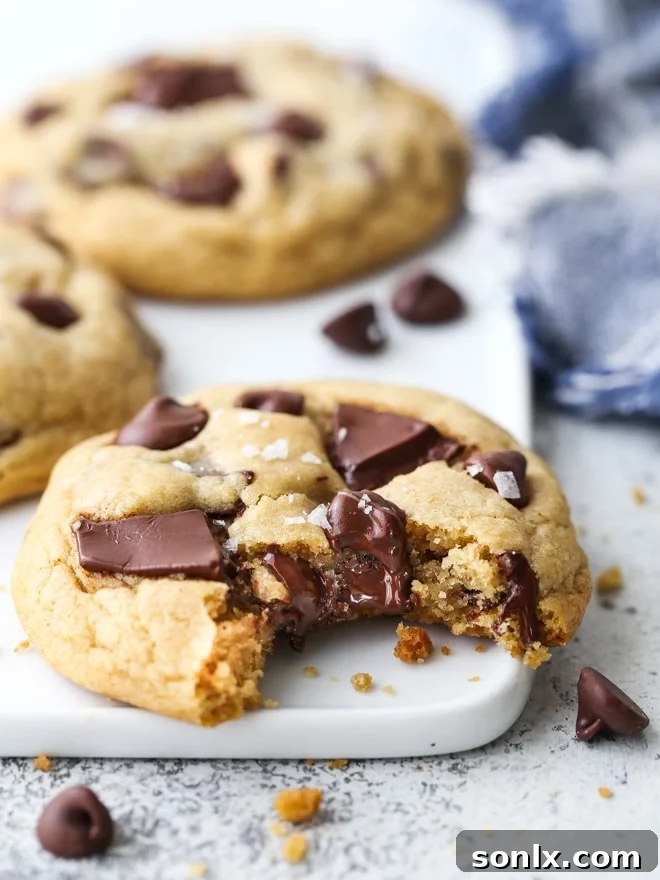 A tray of perfectly golden chocolate chip cookies, fresh from the oven, showcasing ideal shape and texture