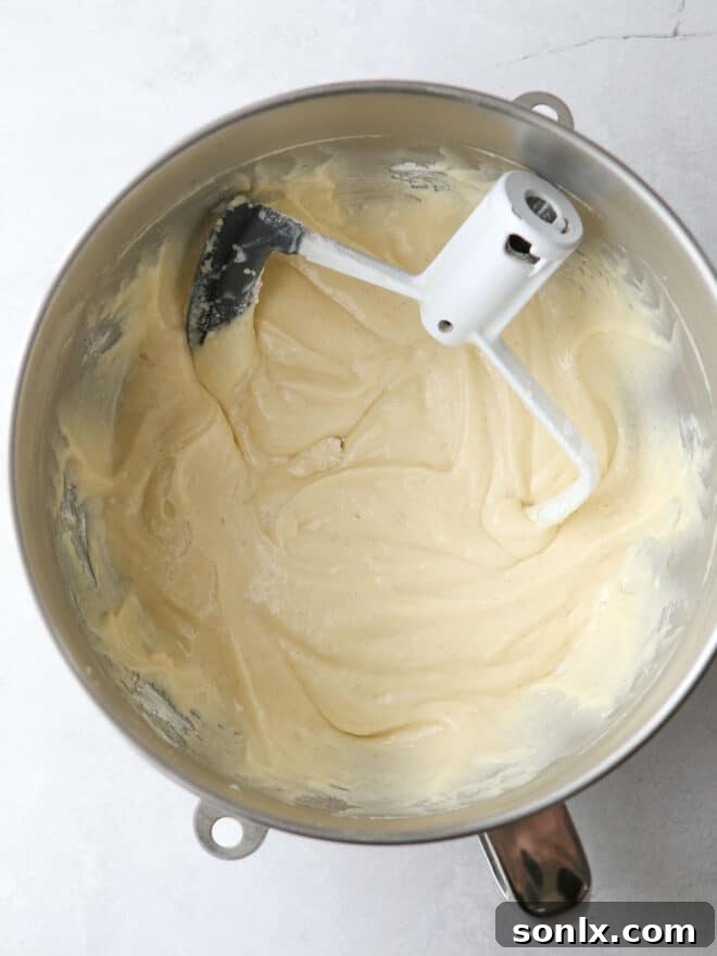 Step-by-step image of cupcake batter being scooped into muffin liners.