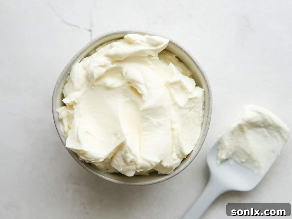 Close-up of fluffy vanilla buttercream frosting being prepared in a stand mixer.