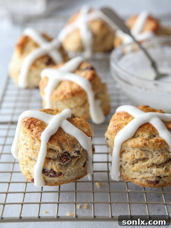 A basket of freshly baked hot cross biscuits, glistening with icing, perfect for a weekend celebration or Easter gathering