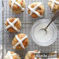 Pouring the glaze on these fun and flavorful hot cross biscuits, showcasing the final presentation