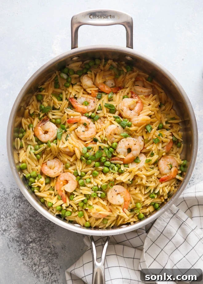 One-Pot Lemon Herb Shrimp and Pea Orzo Pasta served in a bowl, garnished with fresh herbs.