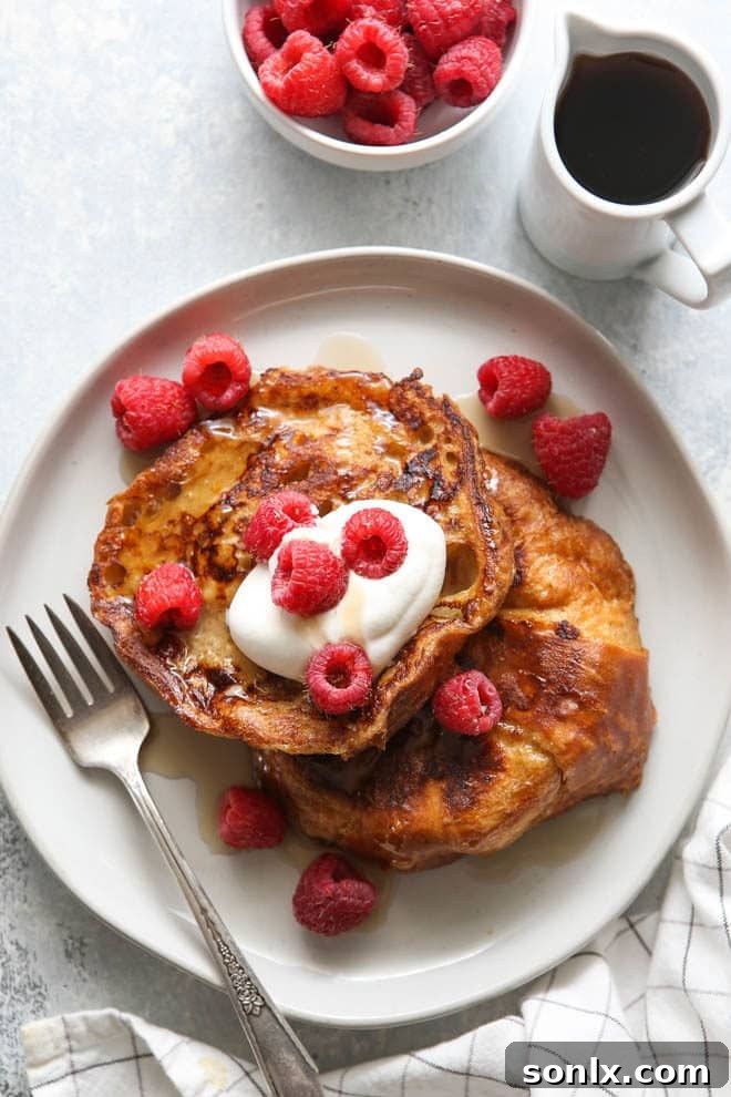 Perfectly cooked, rich and luxurious croissant French toast with a light dusting of powdered sugar