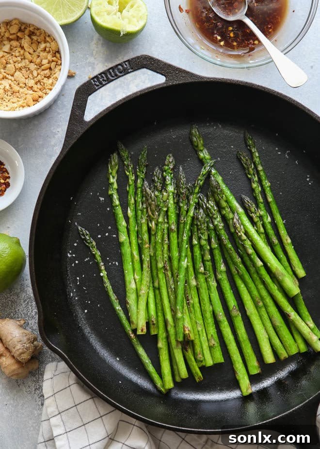 Sauteed asparagus dressed with a ginger-lime sauce and topped with peanuts