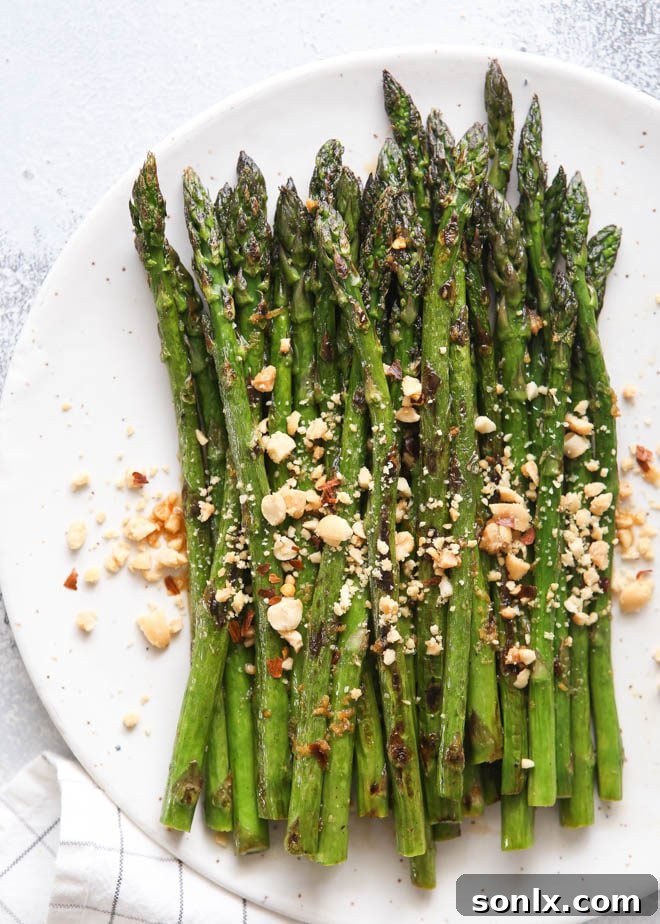 Sauteed asparagus dressed with a ginger-lime sauce and topped with peanuts