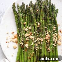 Sauteed asparagus dressed with a ginger-lime sauce and topped with peanuts