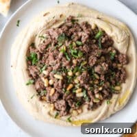 Hummus with spiced beef and pine nuts, beautifully plated and ready to be served.