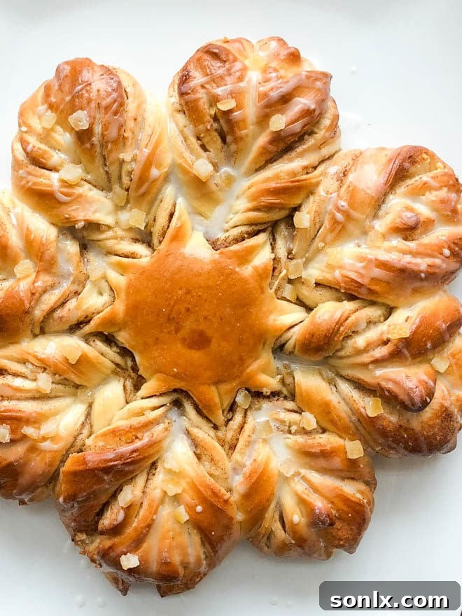 A beautifully baked orange, brown sugar, and cinnamon twist star bread, fresh from the oven.