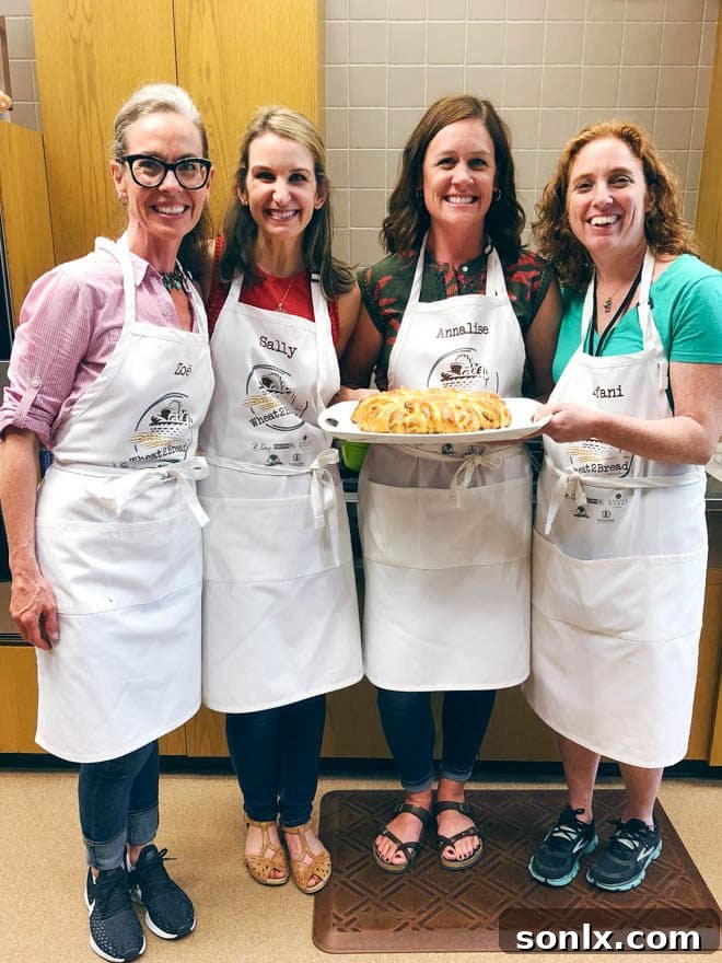 A group of baking bloggers happily collaborating on a bread recipe in the kitchen.