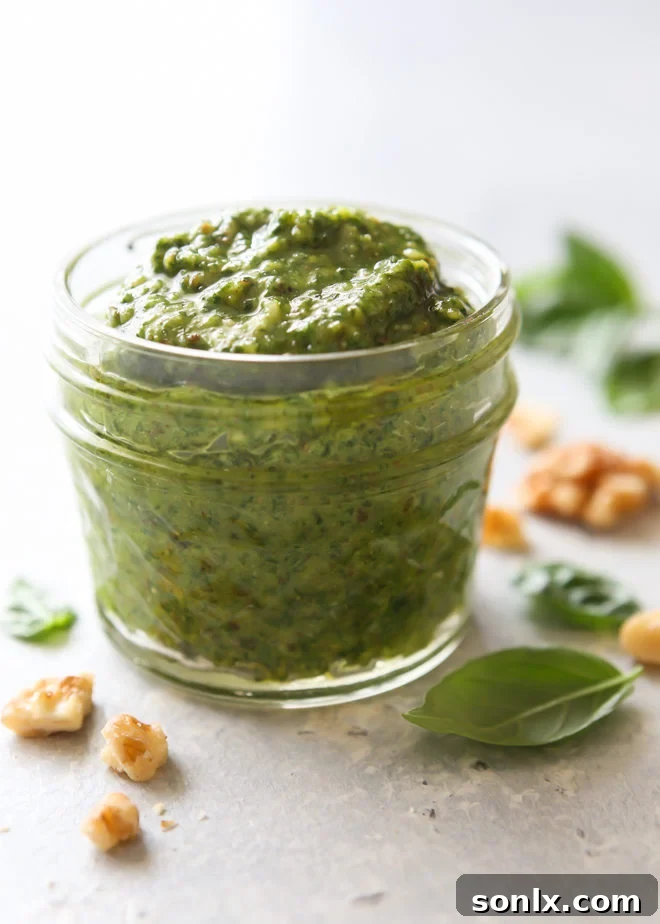 Basil walnut pesto stored in jars and ice cube trays for freshness