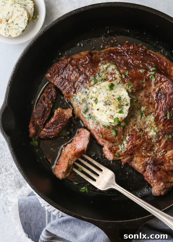 Perfectly grilled ribeye steaks with vibrant Cowboy Butter