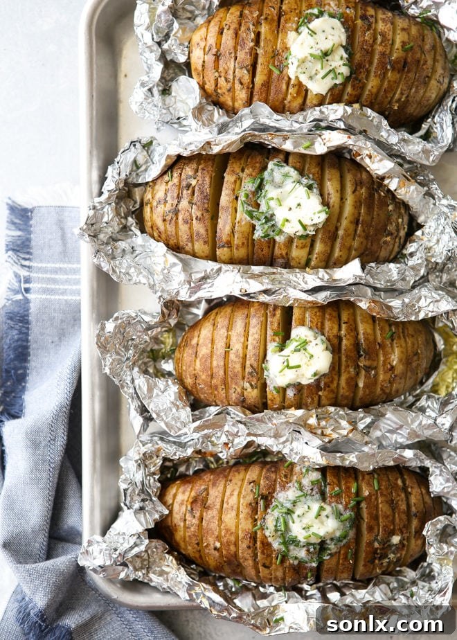 Crispy grilled hasselback potatoes served with a dollop of chive butter