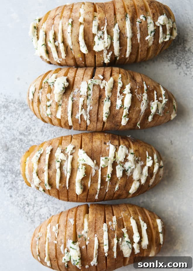Hasselback potatoes with chive butter ready for grilling