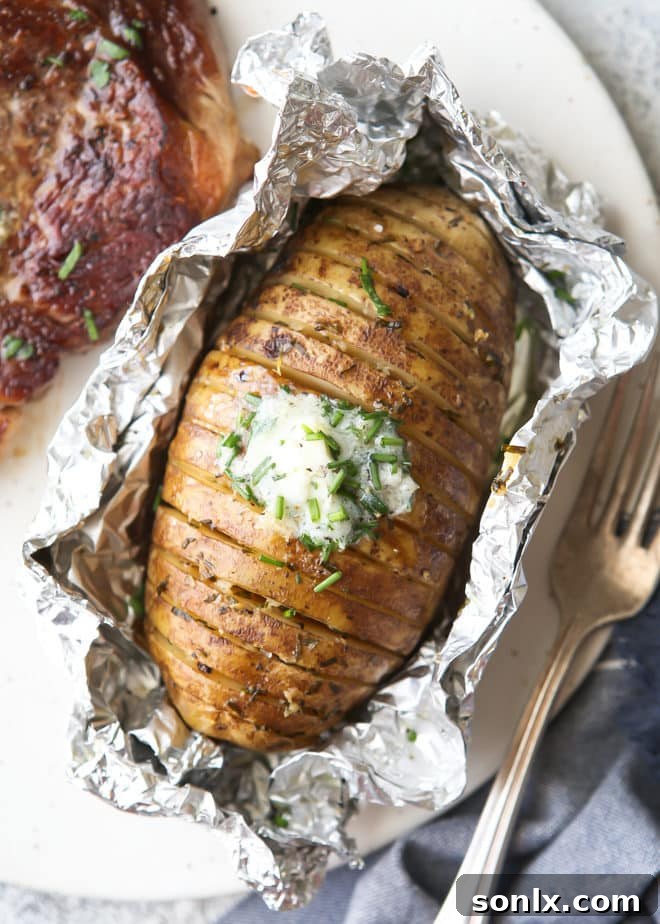 Close-up of grilled hasselback potatoes with melted chive butter