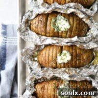 Crispy Grilled Hasselback Potatoes with Fresh Chive Butter 6 Grilled Hasselback Potatoes with Chive Butter ready to serve