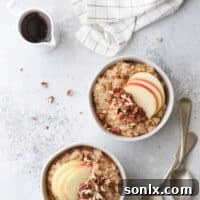 Wholesome Apple Cinnamon Oatmeal Bowls topped with pecans and maple syrup, perfect for fall.