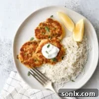 Crispy salmon patties with a side of creamy dill sauce and lemon.