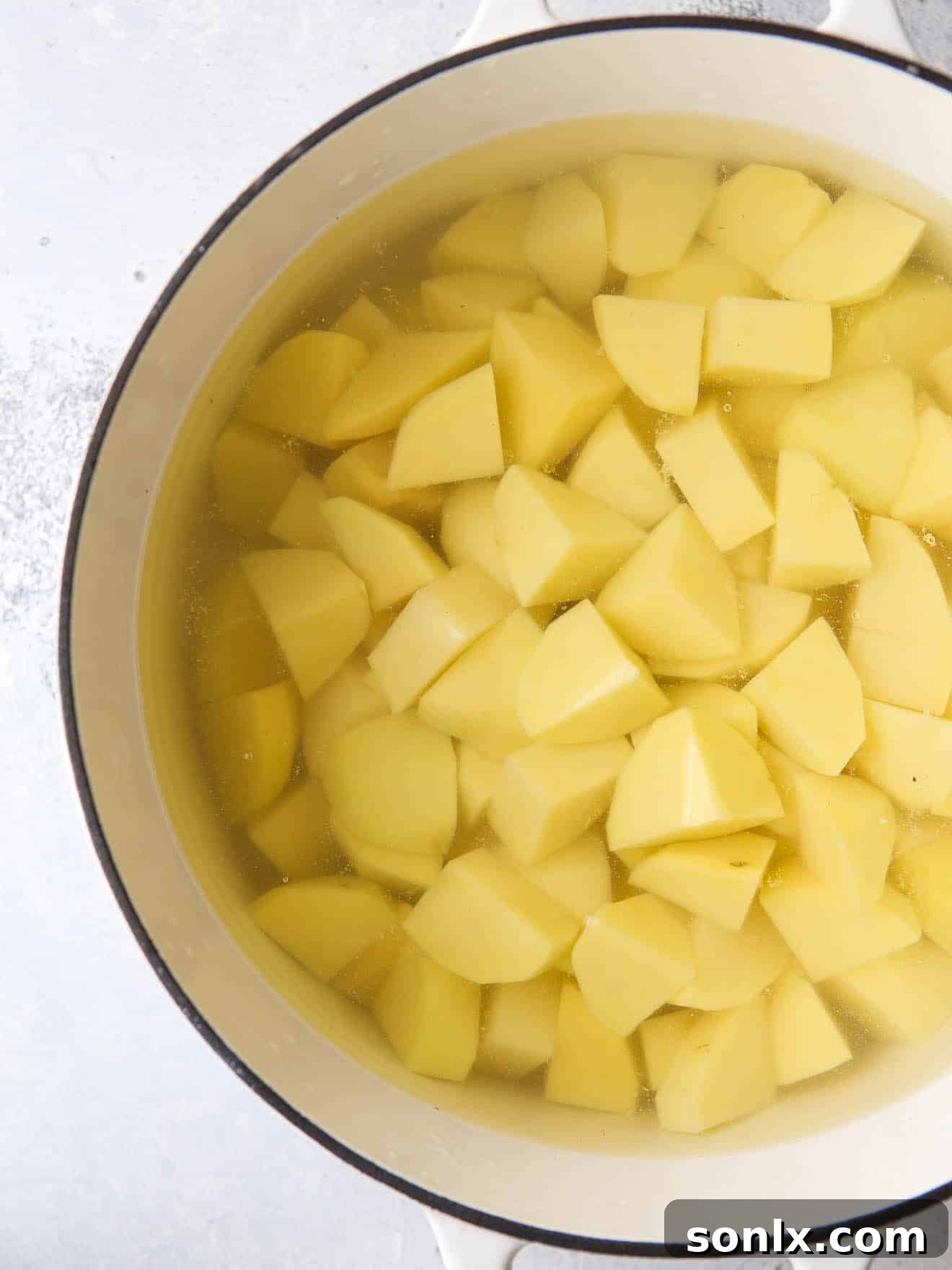 sliced potatoes in water in pot