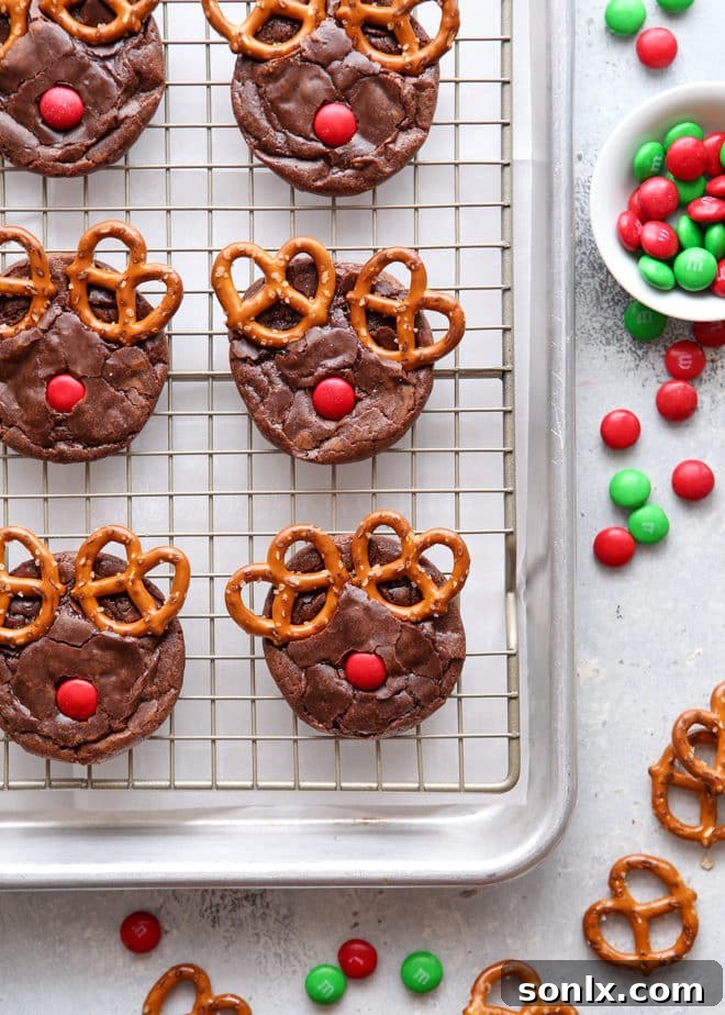 Delicious and easy Rudolf brownie cookies decorated with pretzels and M&Ms, perfect for holiday baking with kids.