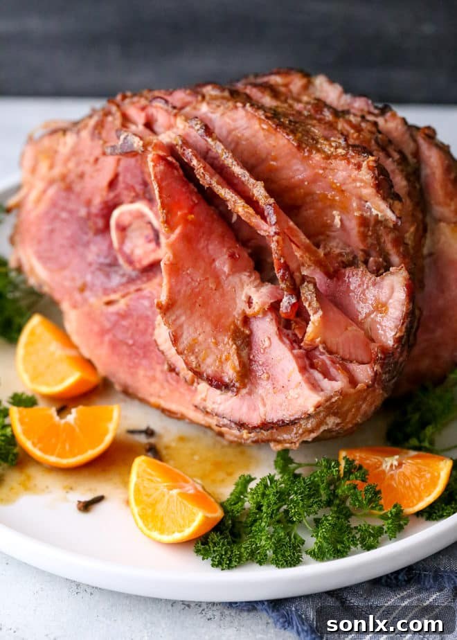 A serving of Citrus Spice Glazed Ham with side dishes, showcasing its delicious appeal.