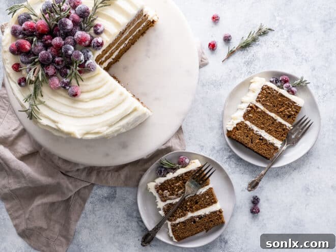 gingerbread layer cake sliced with slices on plates, cranberries for garnish