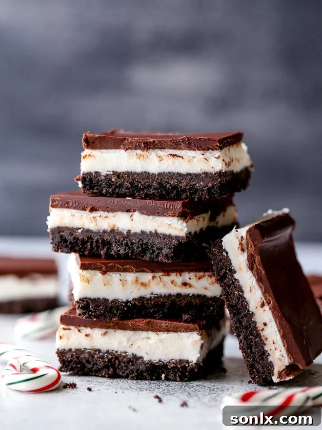 Chocolate peppermint bars are easy to make and so delicious! Layers of chocolate cookie crust, peppermint filling, and dark chocolate topping.