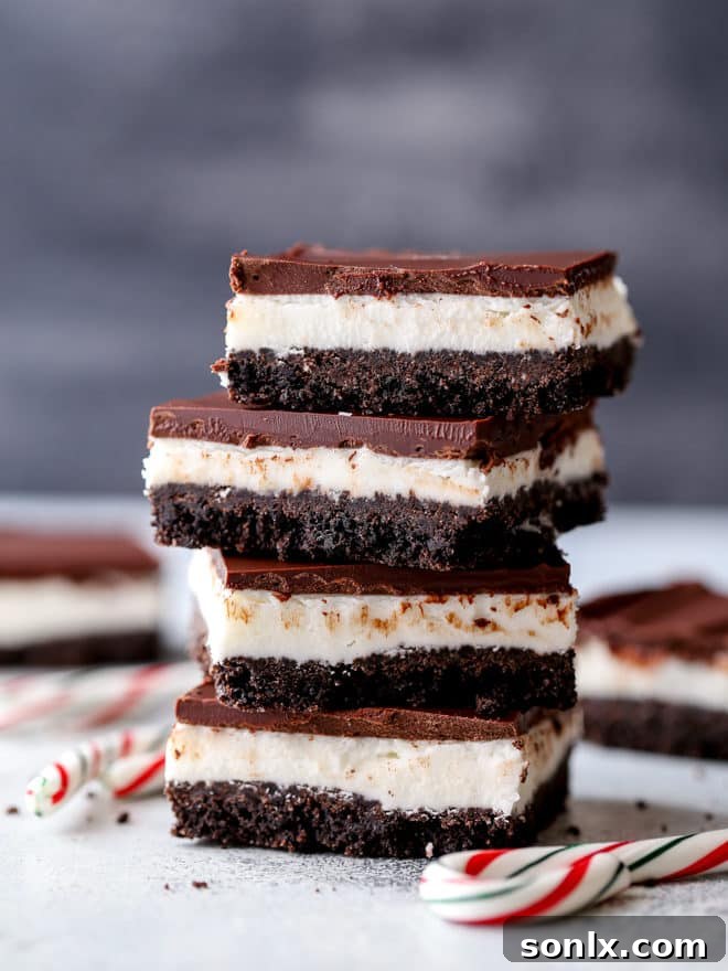 Beautifully layered chocolate peppermint bars, ready for serving. A perfect holiday dessert.