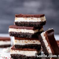 Chocolate peppermint bars are easy to make and so delicious! Layers of chocolate cookie crust, peppermint filling, and dark chocolate topping.