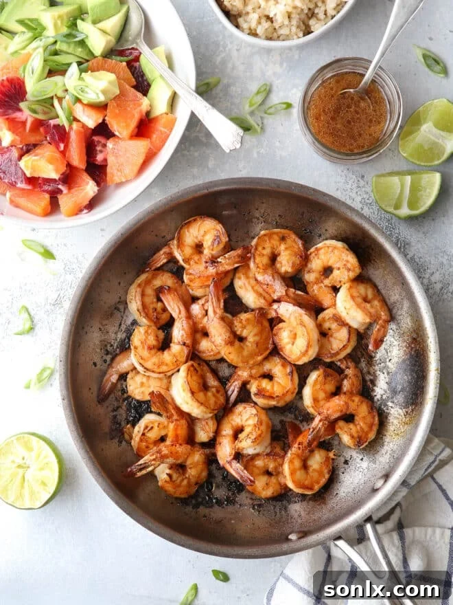 Perfectly cooked citrus shrimp, golden pink and tender, in a skillet.