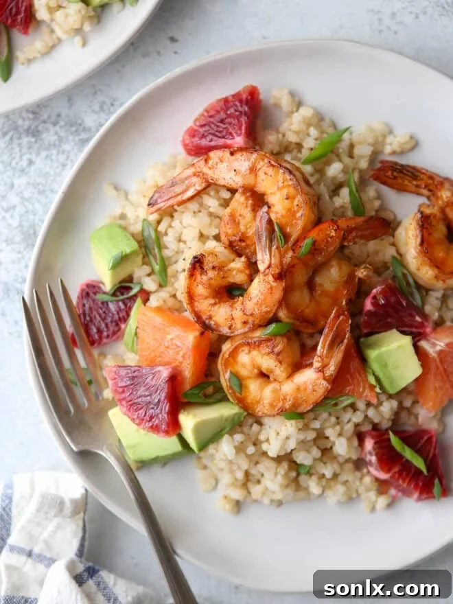Top-down view of a completed citrus shrimp rice bowl, ready to be enjoyed.