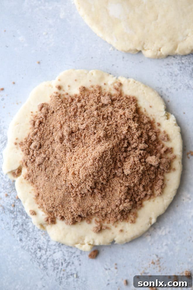 A stack of perfectly baked cinnamon sugar scones, glistening with vanilla glaze.