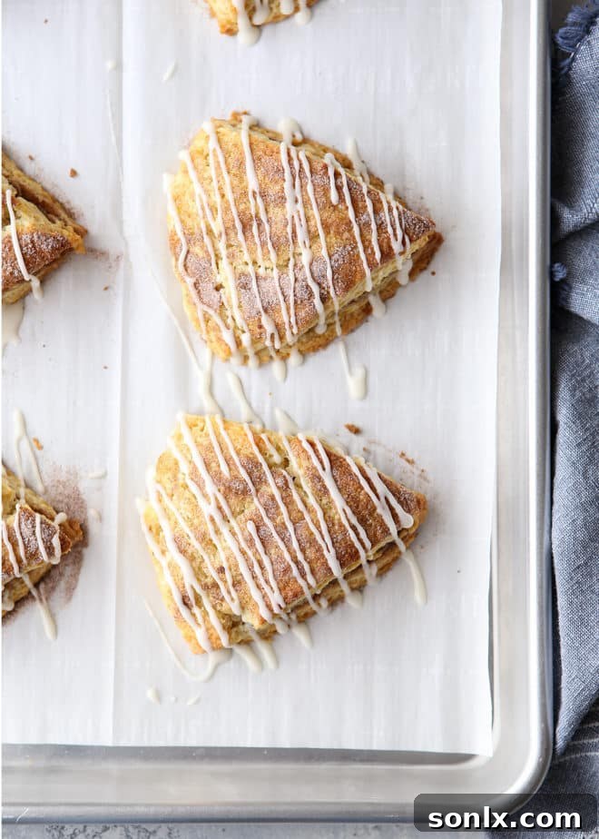 Warm cinnamon sugar scones drizzled with vanilla glaze, ready to be served.