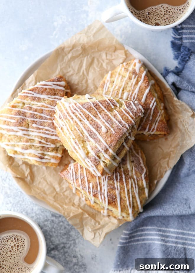 A close-up of a single cinnamon sugar scone, showing its fluffy interior and sweet glaze.