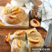 Freshly baked peach focaccia with a golden crust and sliced peaches