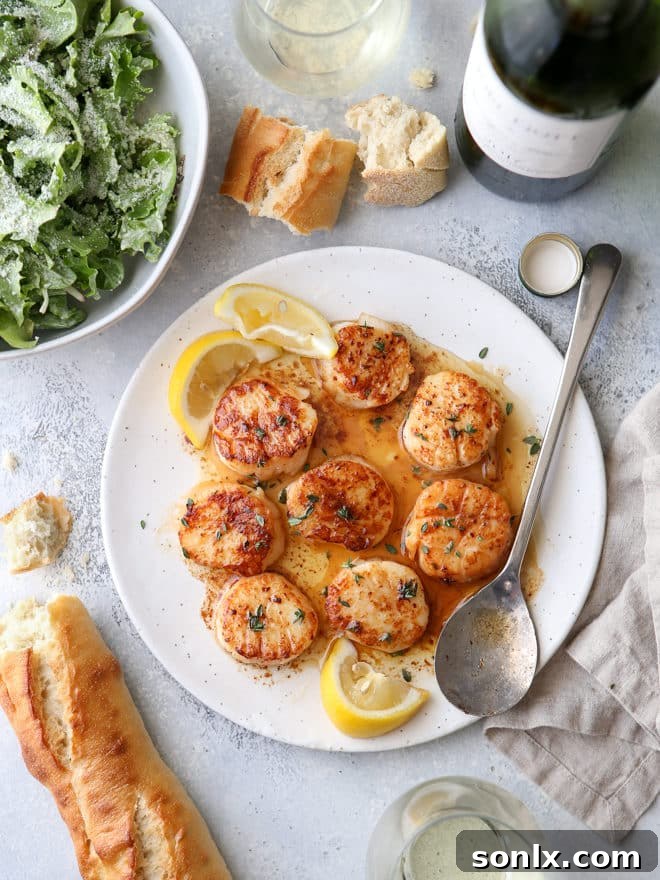 Close-up of perfectly cooked pan-seared scallops with lemon butter sauce, highlighting their golden crust.