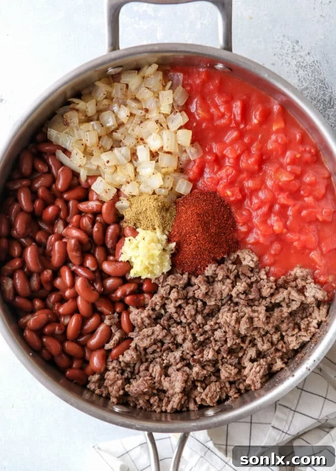 Ingredients for easy homemade chili simmering in a pot.