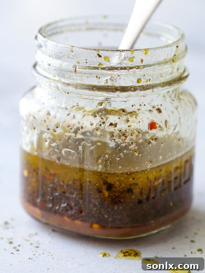 Ingredients for a homemade Italian dressing in a jar.