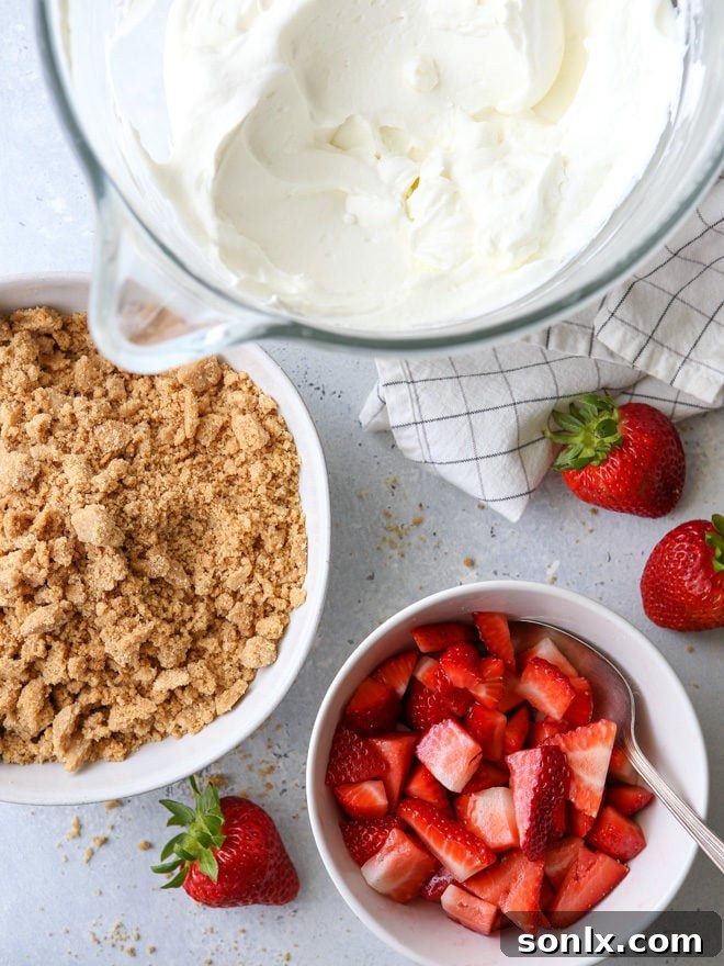 Close-up of a refreshing Strawberry Yogurt Parfait, showcasing layers of bright red strawberries, smooth white yogurt whipped cream, and golden brown graham cracker crumble.