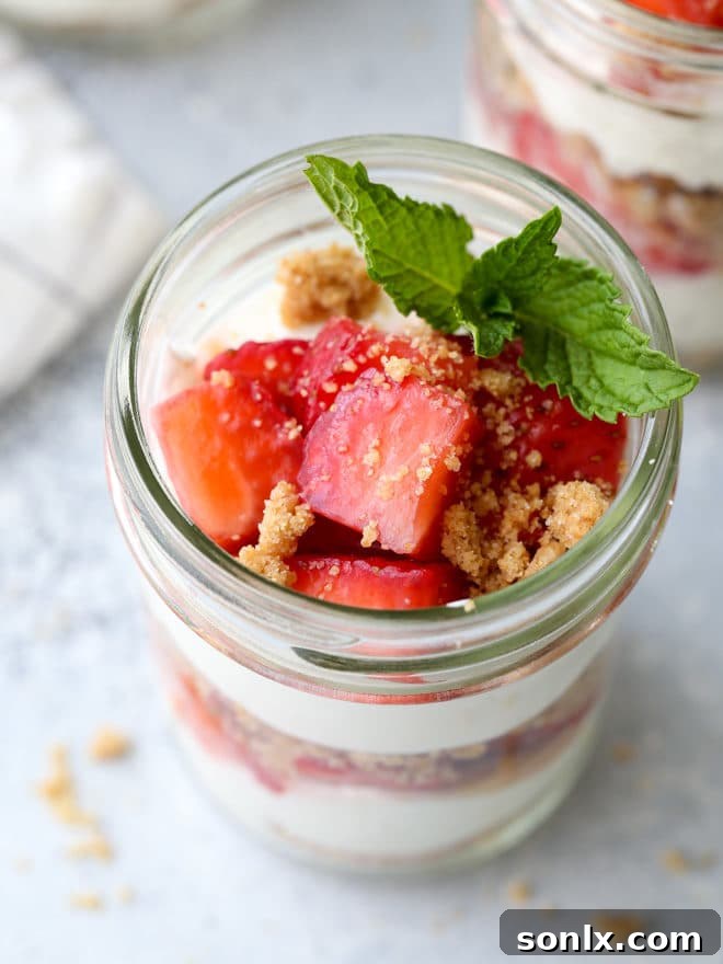 Five Strawberry Yogurt Parfaits arranged appealingly on a wooden board, ready to be served as a refreshing, healthy summer dessert.