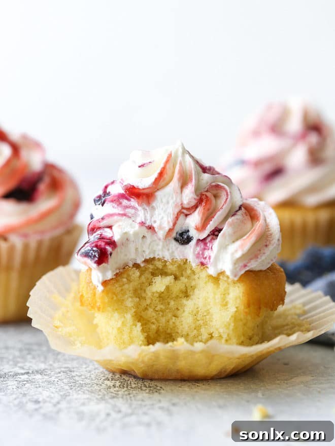 Delicate vanilla cupcakes topped with buttercream frosting swirled with berry preserves are lovely and delicious!