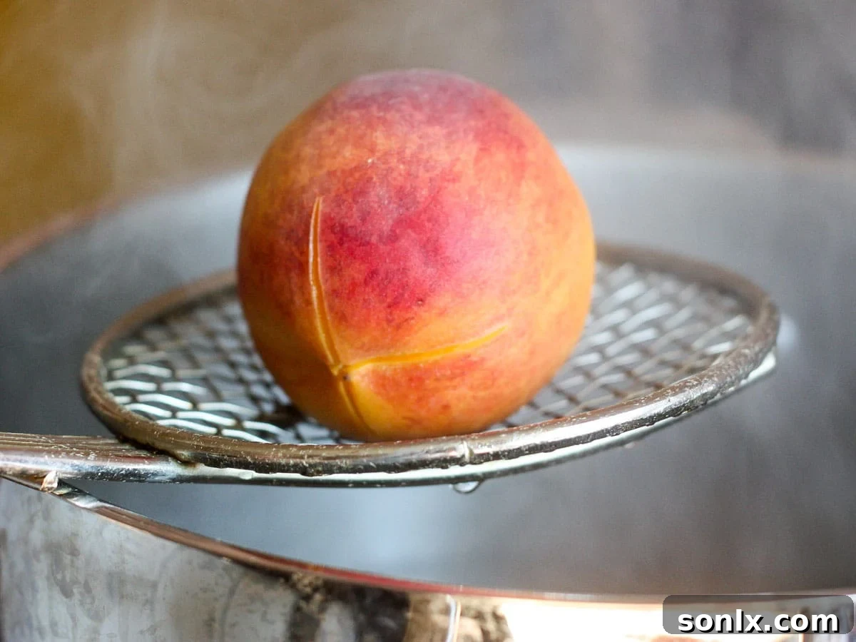 blanched peach removed from boiling water