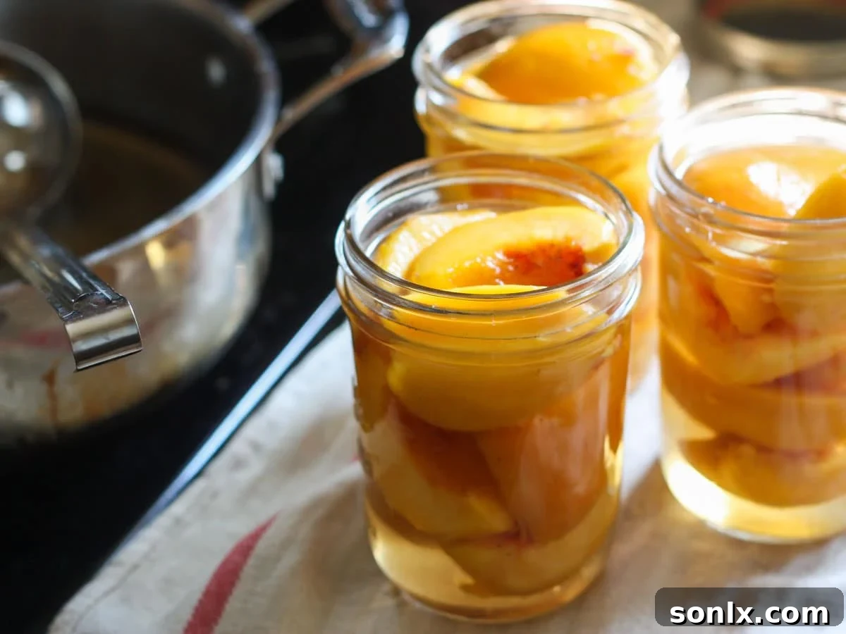 adding peaches and syrup to canning jars