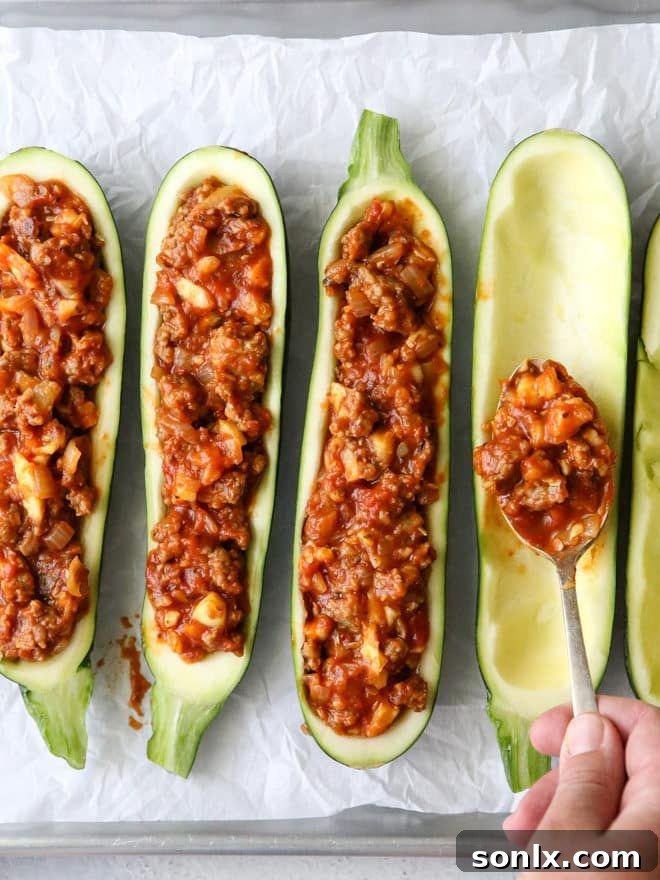 Making sausage stuffed zucchini boats, step by step process
