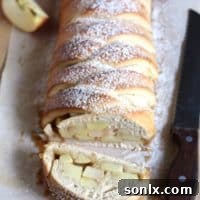 Beautifully braided caramel apple loaf, golden brown and glistening.