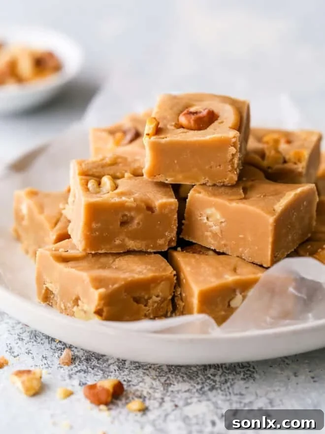 Sliced brown sugar fudge squares on a white plate, showcasing its rich caramel color and a few visible walnut pieces.