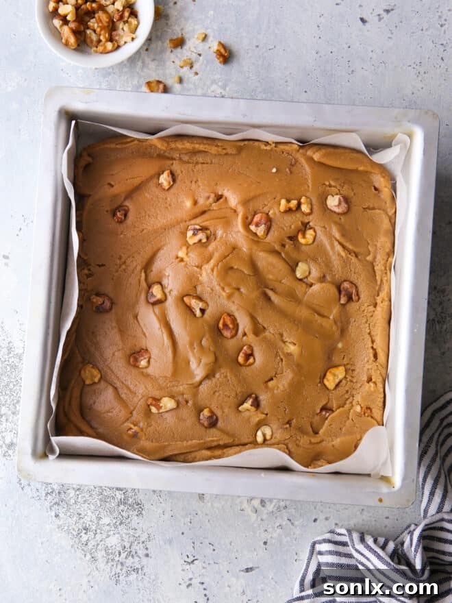 A pan of freshly made brown sugar fudge, cooling and ready to be sliced.