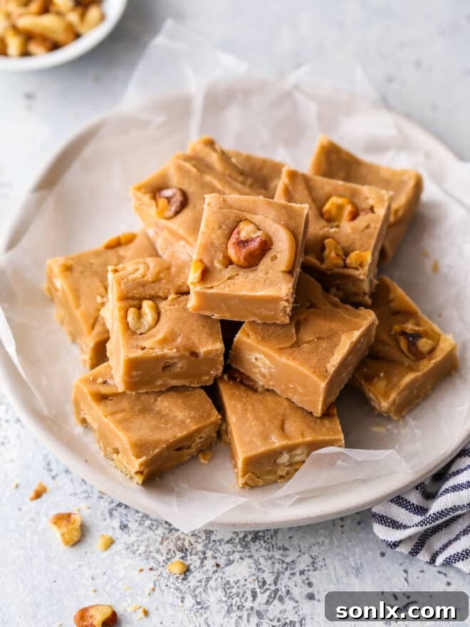 Close-up shot of sliced brown sugar fudge squares arranged neatly on a plate, highlighting the creamy texture and visible walnut pieces.