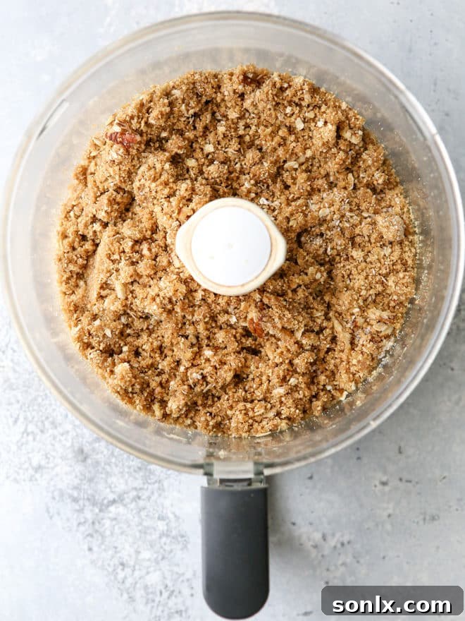 Homemade graham cracker streusel with visible pecans and oats, perfect for a crust or topping