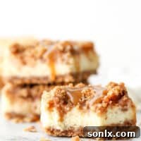 Layers of graham cracker streusel, smooth cream cheese filling, cinnamon apple chunks, and caramel drizzle make up these rich and creamy caramel apple cheesecake bars.